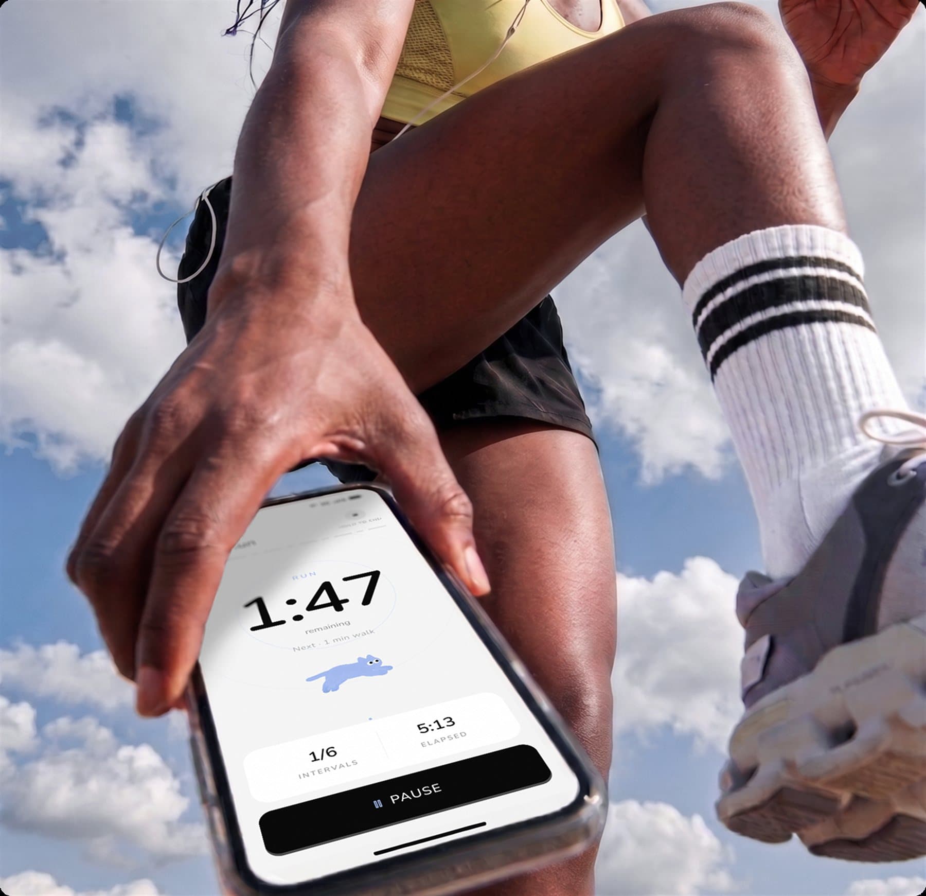 A runner stretching mid-run, checking the Molorun app on their phone